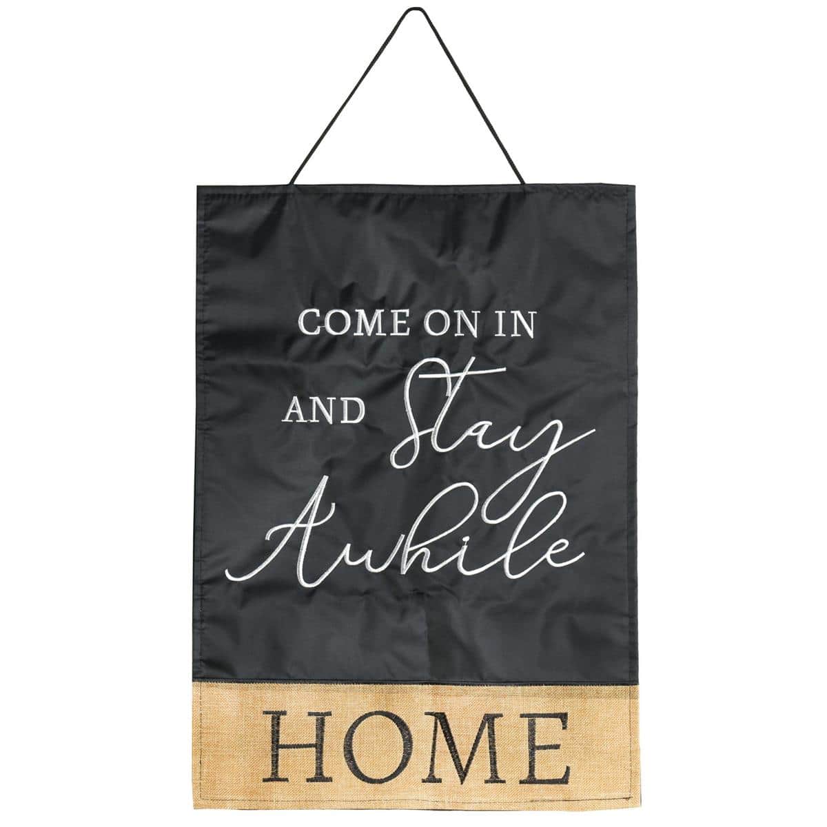 Front door with a fabric door hanger reading "Come On In And Stay Awhile" centered on a farmhouse style door, showing the greeting banner as porch decor and entryway accent.