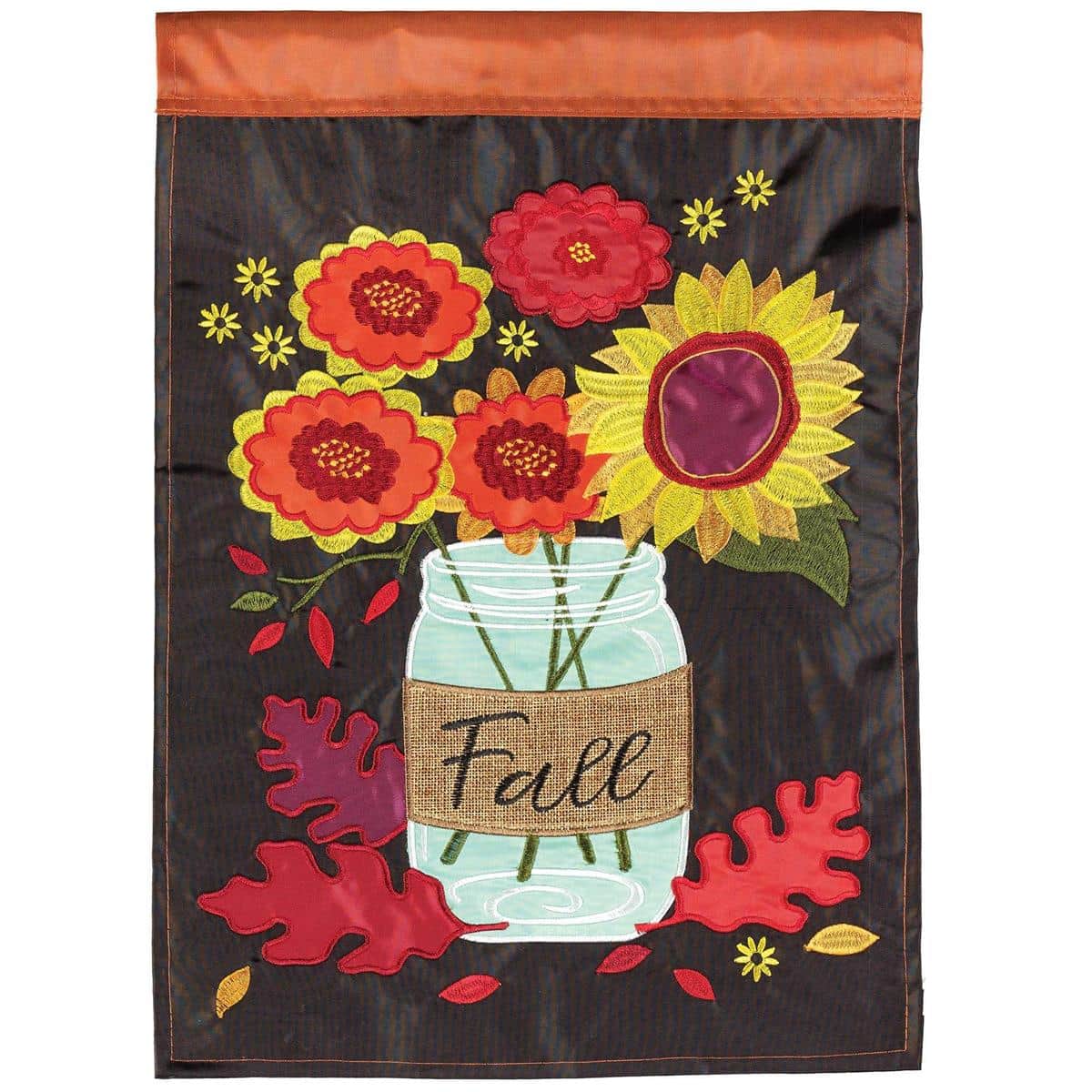 A 29 by 42 inch Fall Mason Jar Sunflower Banner Flag showing a rustic mason jar filled with golden sunflowers, layered double applique petals, autumn leaves, and warm harvest tones; displayed on a porch arm with visible stitched hems and a sleeve for standard flag poles, the image emphasizes sunflowers and farmhouse styling for seasonal curb appeal.