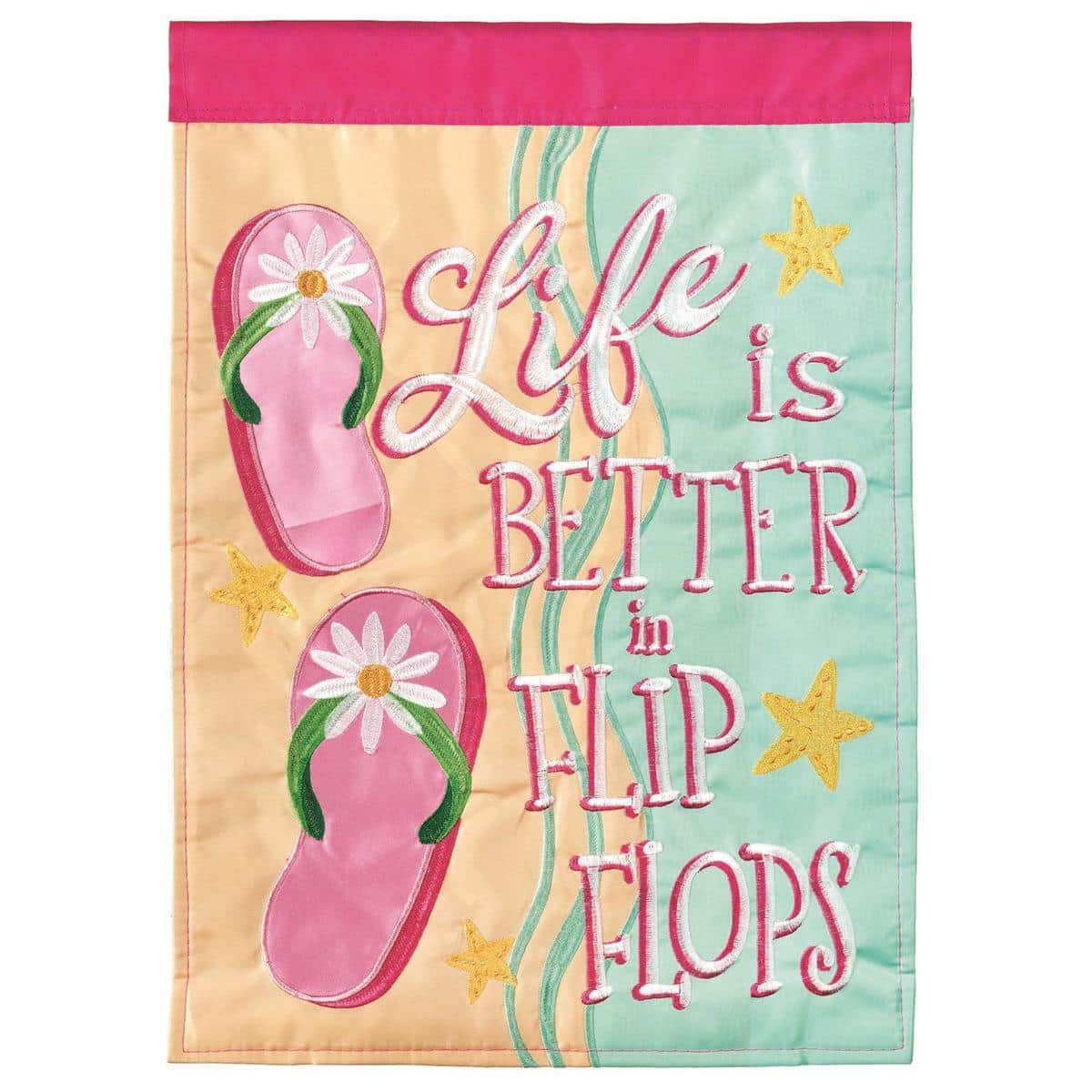 13x18 WaterfrontFlops Flip Flops garden flag showing layered double applique flip flop motifs in coastal colors hung on a black metal garden flag pole in a sunny yard near flowers and a porch step.