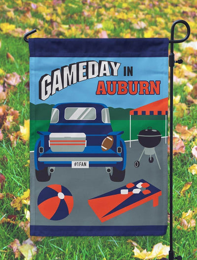 Alabama Crimson white 13x18 double applique garden flag on a metal stand, sports themed yard sign with bold crimson and white layers against greenery