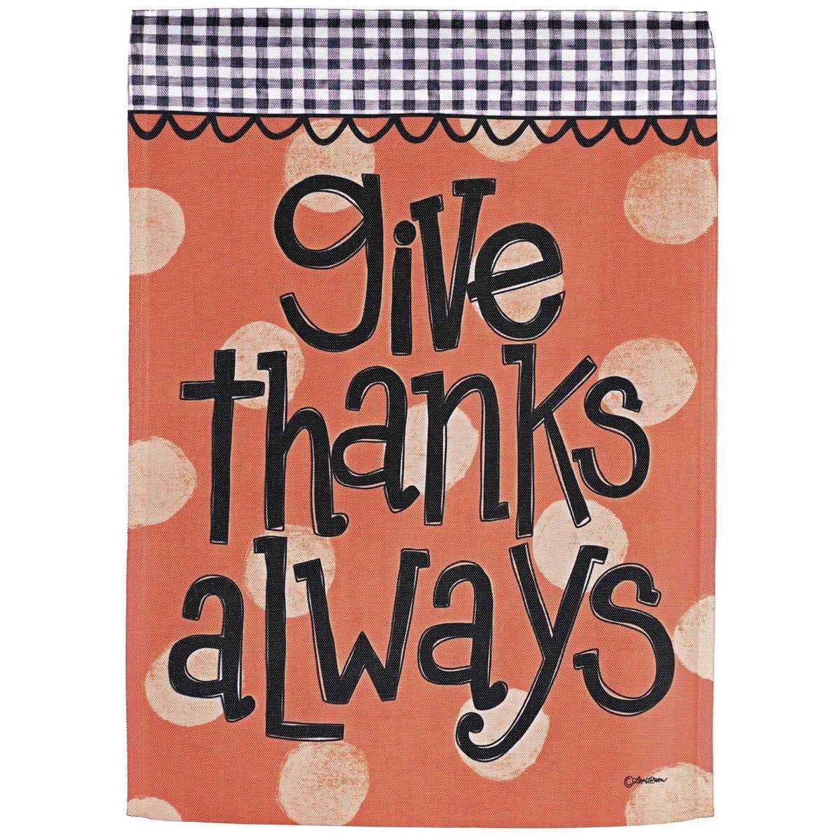 Fall polka dot flag reading "Give Thanks Always" in warm orange and cream tones with leaf accents displayed on a porch flagpole and nearby pumpkins for seasonal styling.