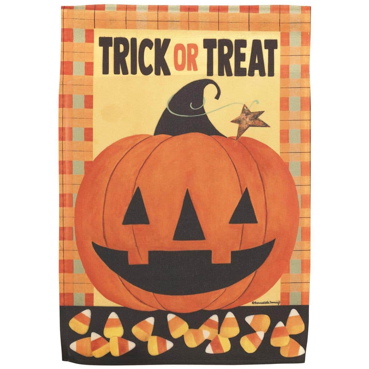 13x18 Jack-O-Lantern garden flag featuring a smiling carved pumpkin face printed on durable polyester, shown on a metal garden flag pole in a yard setting with fall leaves and porch lighting