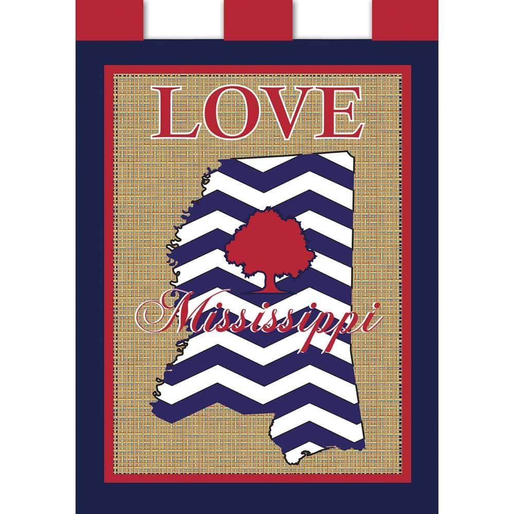 Love Mississippi burlap double applique 13x18 garden flag hanging on a black metal stand in a front yard, rustic tan weave with layered letters and bold state pride