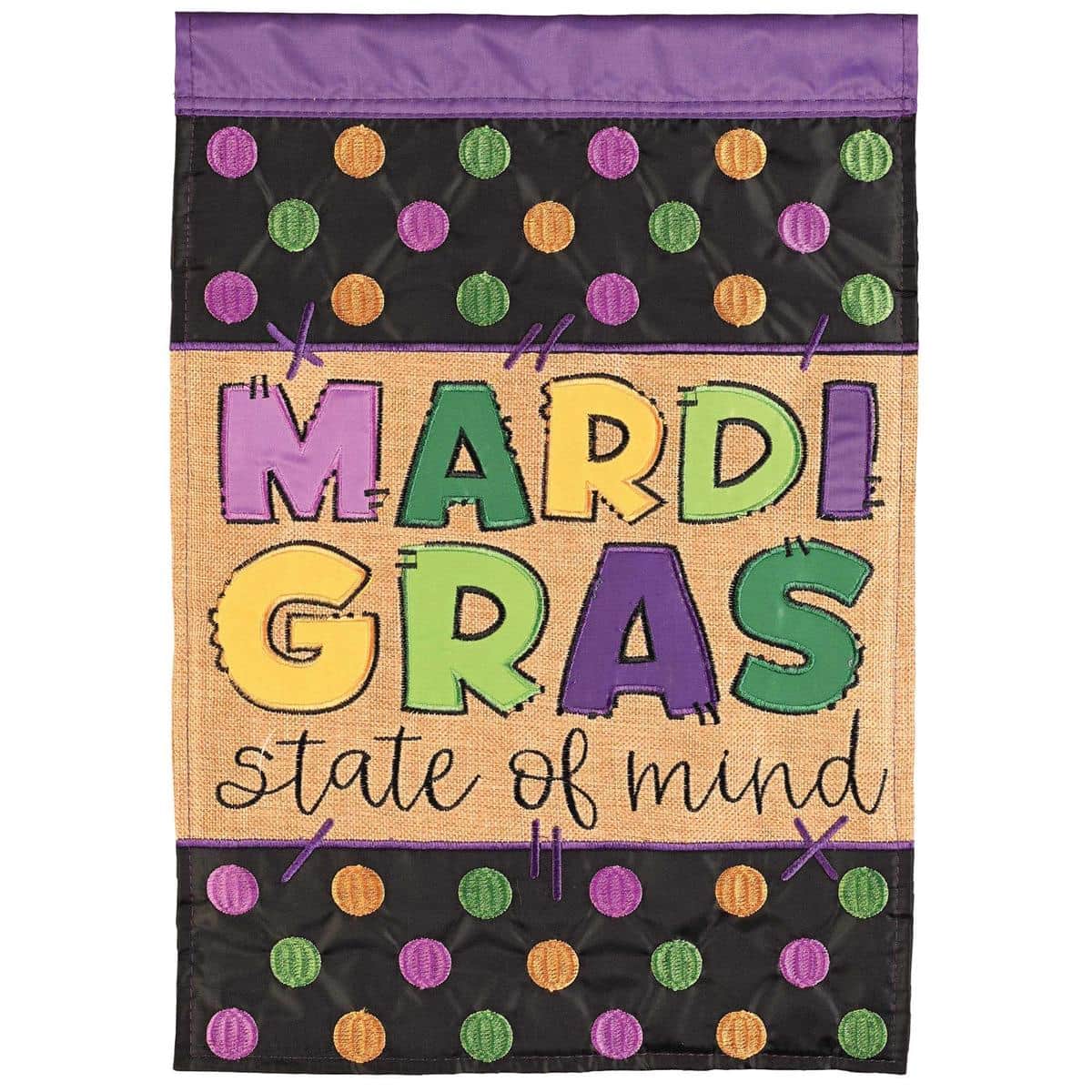 13x18 Mardi Gras State Of Mind garden flag in purple, green, and gold with masks and beads, double applique construction, pole sleeve on a standard stand by a front walkway