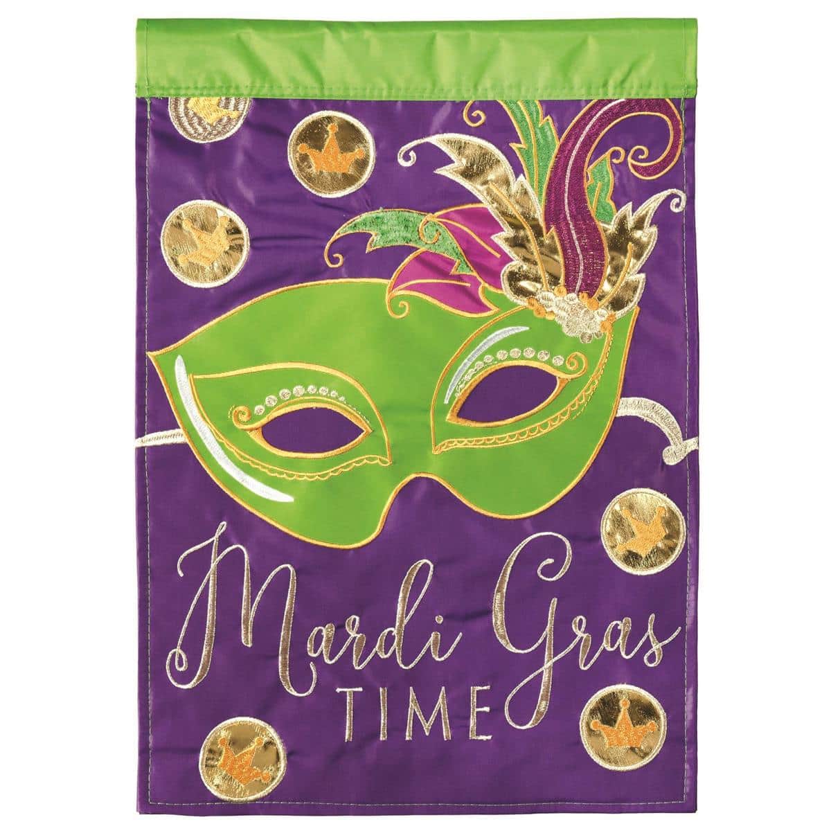 Photo of the Mardi Gras Time 13x18 double applique garden flag mounted on a garden stake with purple, green, and gold masks, bead strands, and fleur-de-lis accents visible against a backyard backdrop and showing layered applique texture.
