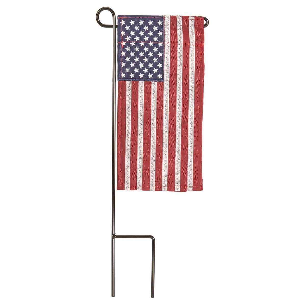 Mini American 4x8 flag with vivid stars and stripes, reinforced hems, and a top sleeve, styled on a small stand for patriotic decor in tight indoor or outdoor spaces.