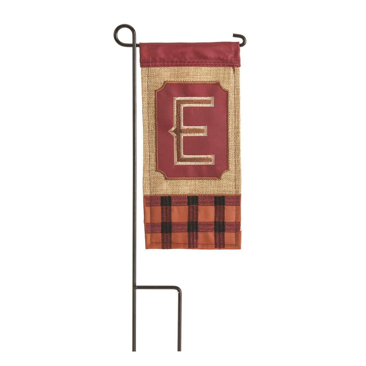 Closeup of 4x8 mini burlap flag displaying a bold letter E monogram with autumn leaf accents, styled in a porch planter for seasonal fall decor.