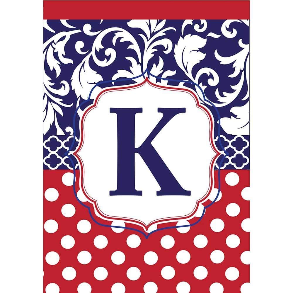Closeup of a red, white, and blue 13x18 garden flag with a bold double applique letter K, readable on both sides and displayed on a standard yard flag stand.