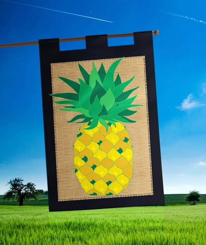 Pineapple burlap banner flag 29x42 inches photographed hanging from a porch pole showing applique pineapple motif, textured natural burlap background, and reinforced stitched hem for outdoor display.