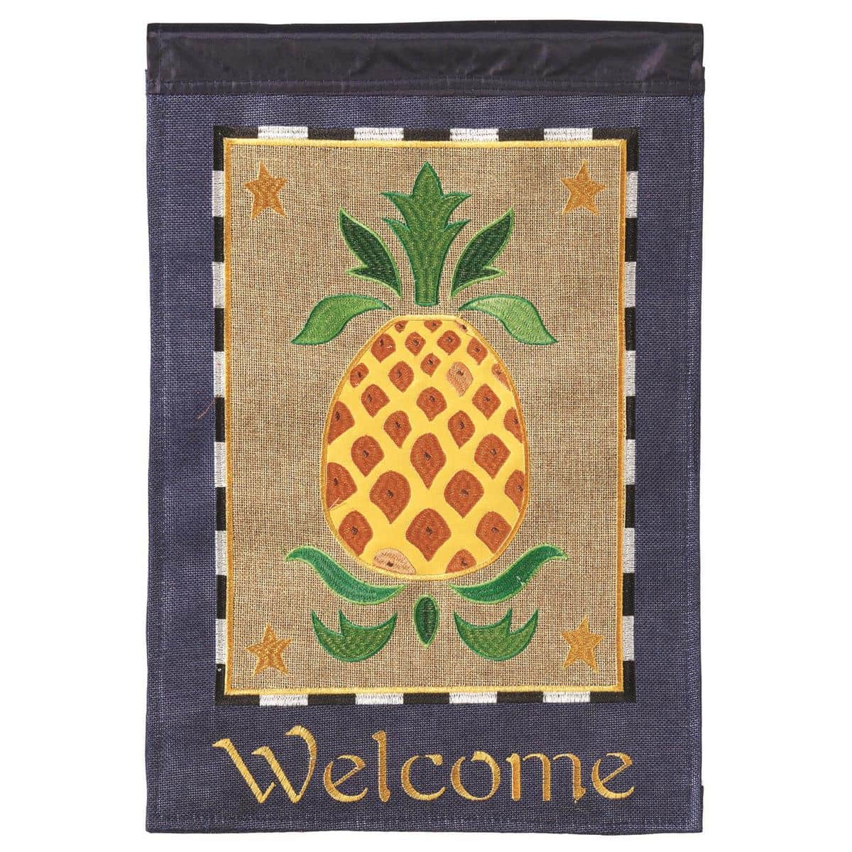 Close-up of Pineapple Welcome burlap garden flag 13x18 with double applique pineapple and stitched Welcome text, hanging on a standard yard flagpole.