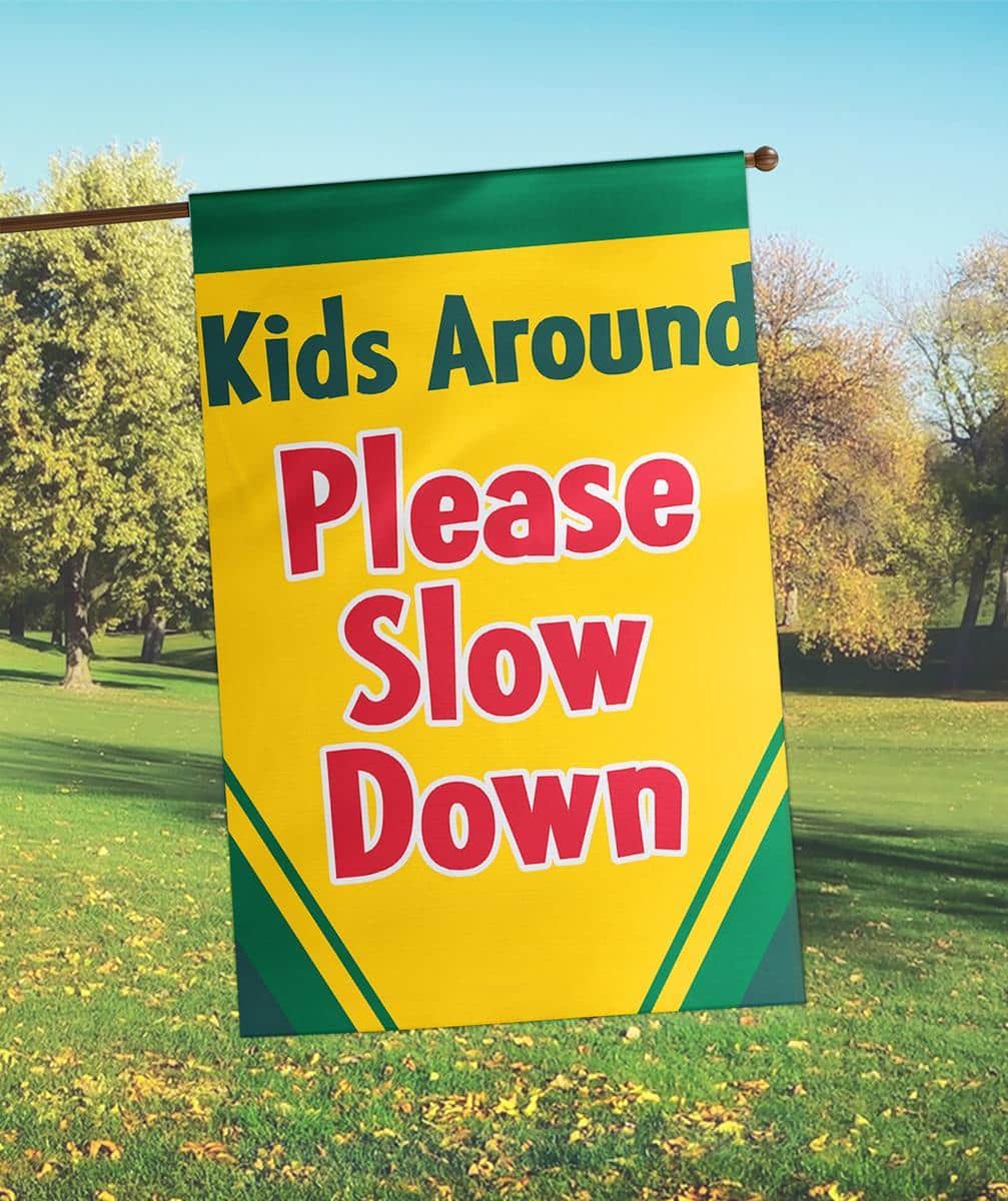 Alt text: 29x42 Please Slow Down fall banner flag double applique with autumn colors and bold safety message for yards and driveways.