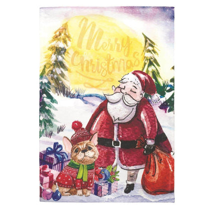 Santa puppy wearing a red Santa hat and festive scarf printed on a 13x18 garden flag displayed on a black metal garden pole in a snowy front yard scene