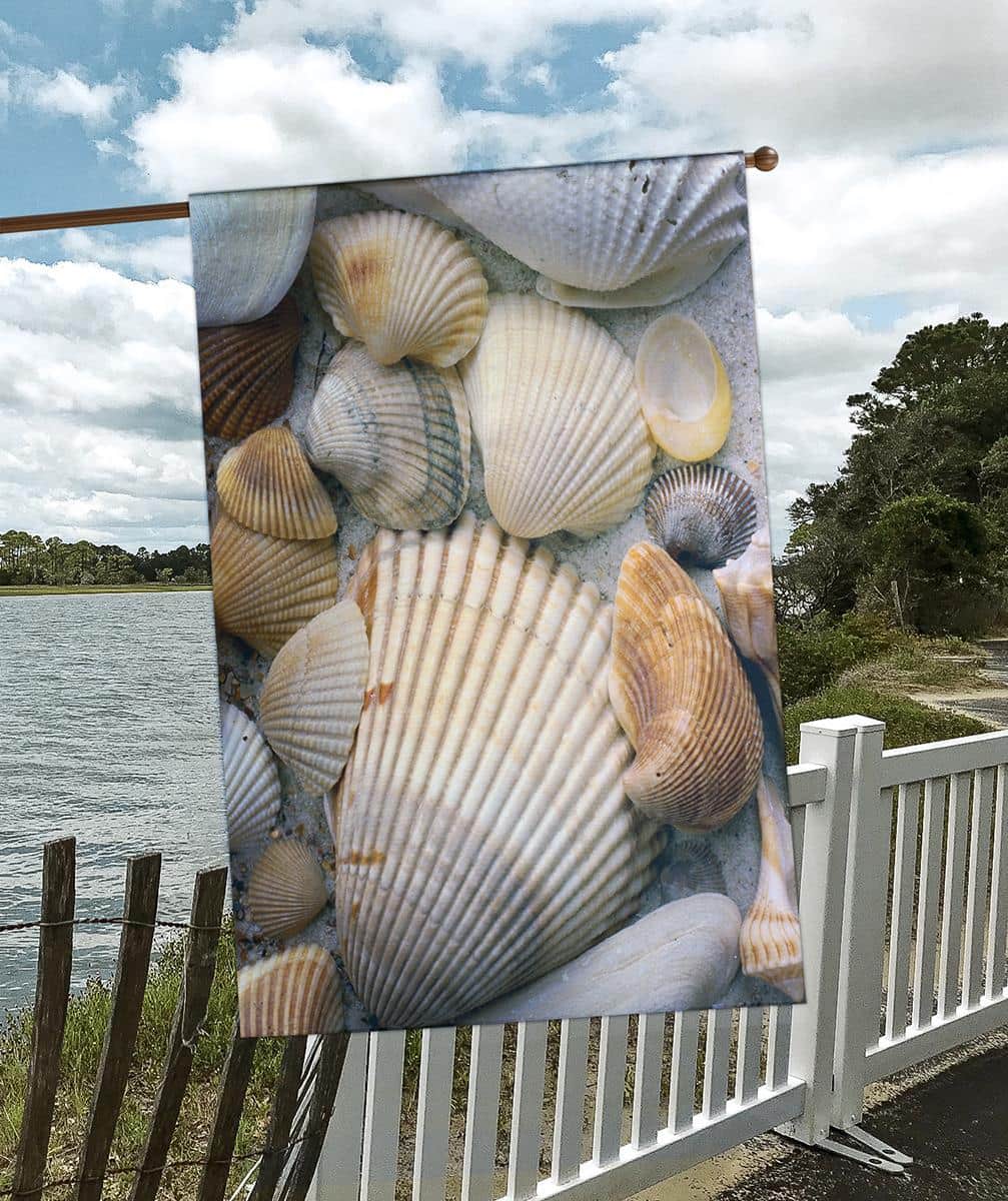 30x44 Seashells Banner Flag showing assorted seashells, starfish, and sand pattern in soft coastal hues printed on outdoor banner fabric for porch pole display.
