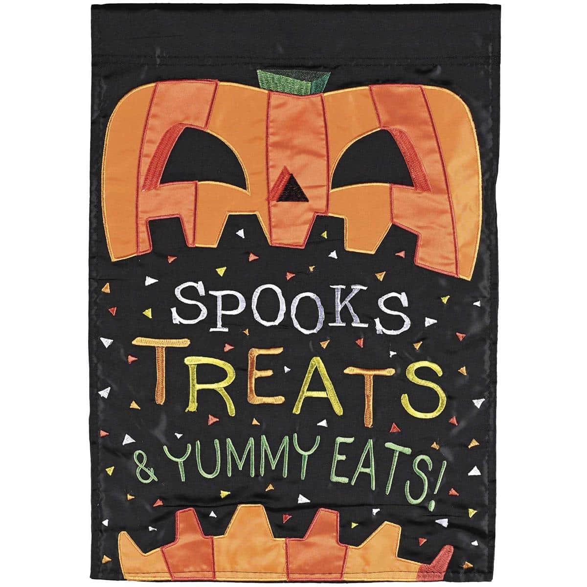 Double applique 13x18 Halloween garden flag reading Spooks Treats Yummy Eats with jack-o-lantern and candy art on a stand by a front walkway.