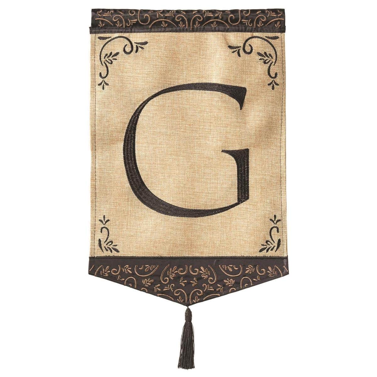 Close-up of 13x18 Tassel Burlap Monogram-G garden flag showing double applique G letter, textured burlap background, decorative tassel, and top sleeve for garden pole.