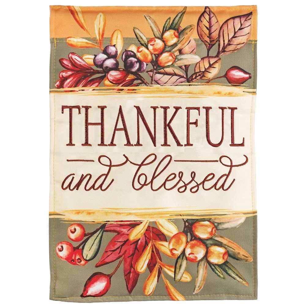 Thankful And Blessed 29x42 double-applique Thanksgiving banner flag with warm harvest lettering and fall leaf accents shown on a front porch pole.