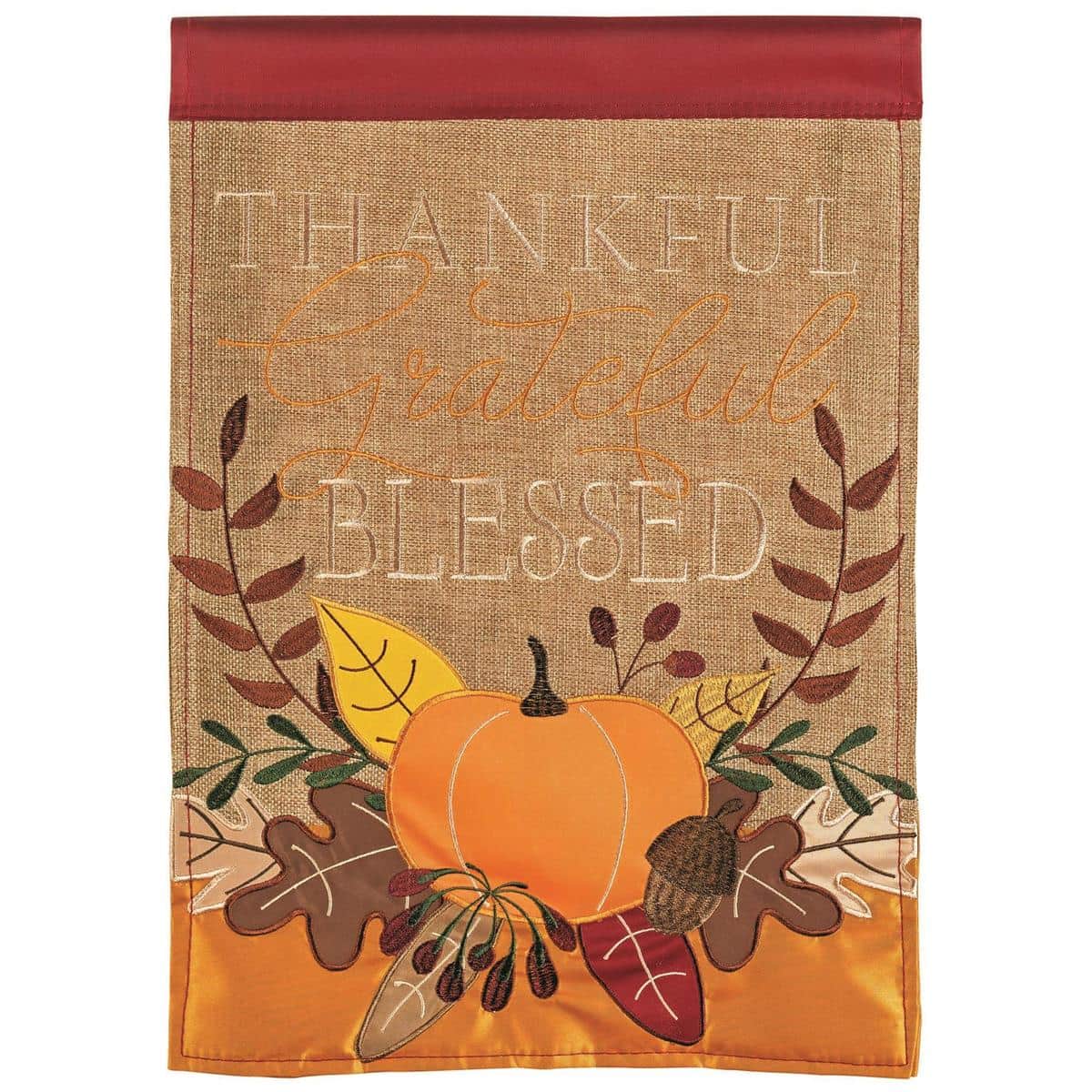 13x18 Thankful Grateful Pumpkin garden flag with double-applique pumpkins, fall leaves, and two-sided stitched lettering, shown on a standard stand in a cozy autumn yard.