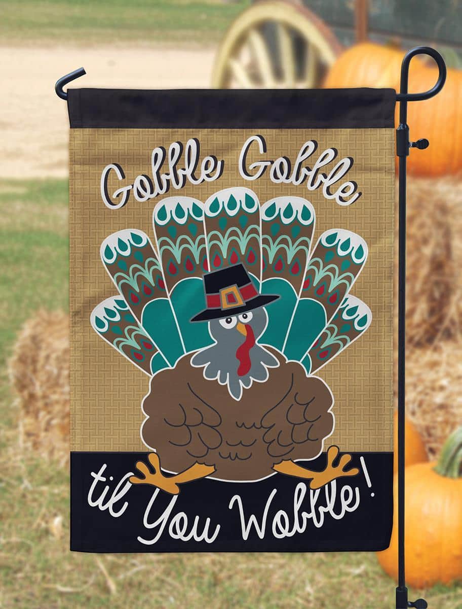 13x18 inch Turkey burlap garden flag with layered double applique turkey motif on rustic burlap background displayed on a metal garden flag stand in a fall porch scene