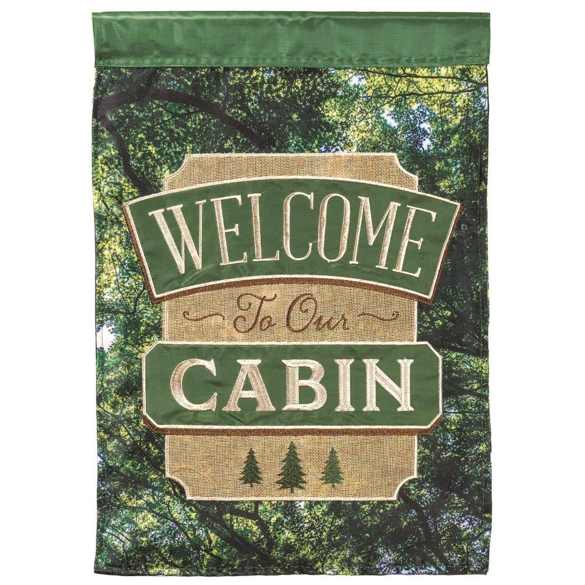 13x18 Welcome To Our Cabin garden flag displayed on a stand, rustic camping theme with layered applique, readable both sides, weather resistant outdoor decor.