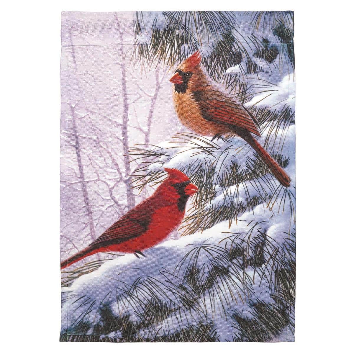Close-up photo of the 13x18 Winter Songbirds Garden Flag showing printed songbirds on snow-dusted branches, muted winter palette, reinforced sleeve and hem visible for garden pole display.
