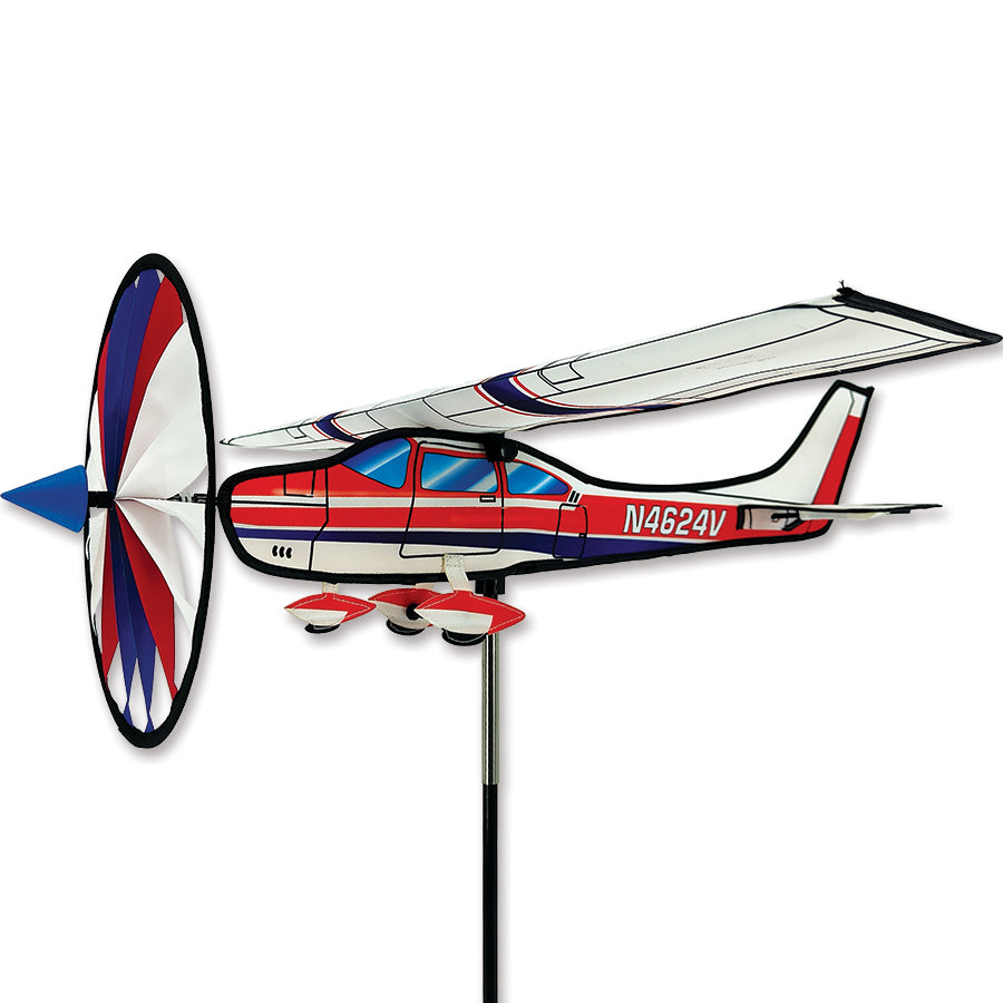 Airplane Spinner lawn ornament featuring a vintage aircraft design, beautifully rotating in an outdoor garden setting against a clear sky.