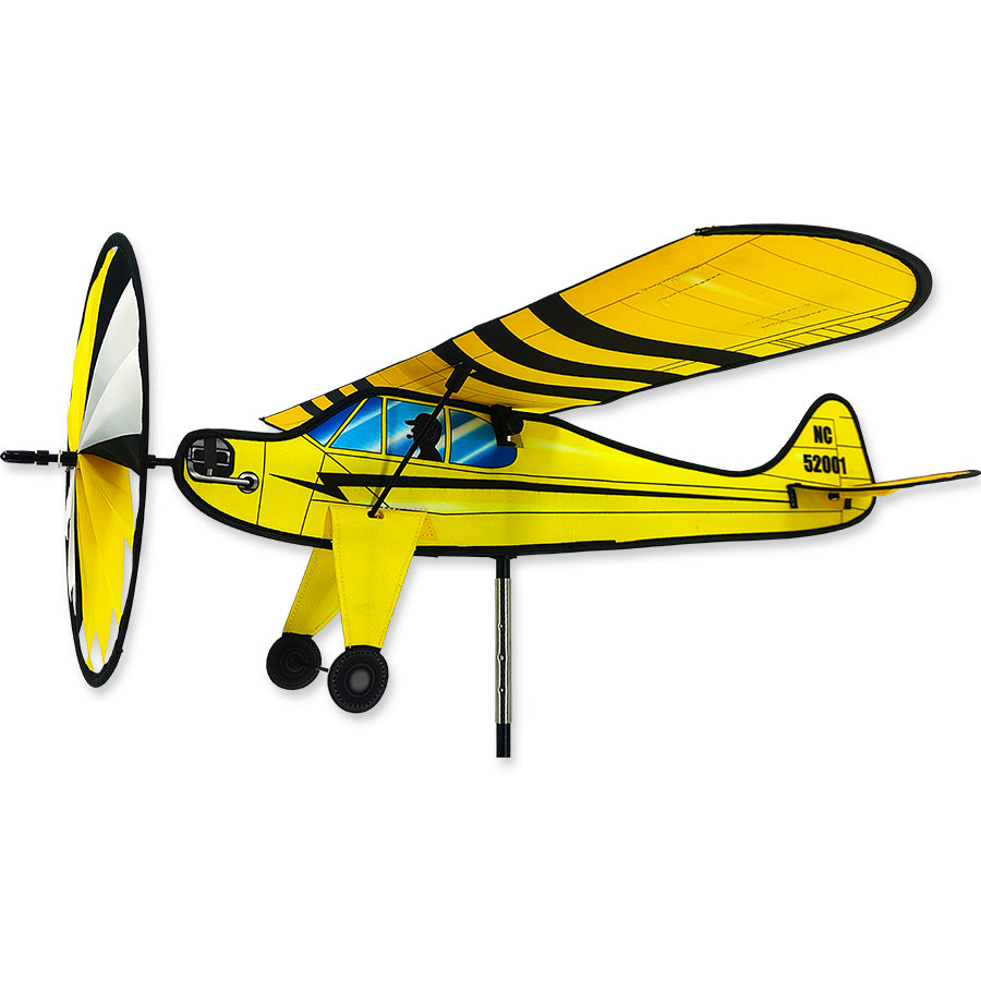 Airplane Spinner - Premier Cub lawn ornament featuring a vintage airplane design, smoothly spinning in an outdoor garden setting with colorful flowers.