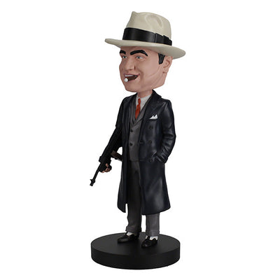 Al Capone Bobblehead standing 8 inches tall, featuring lifelike details, displayed on a shelf with a vintage theme in the background.
