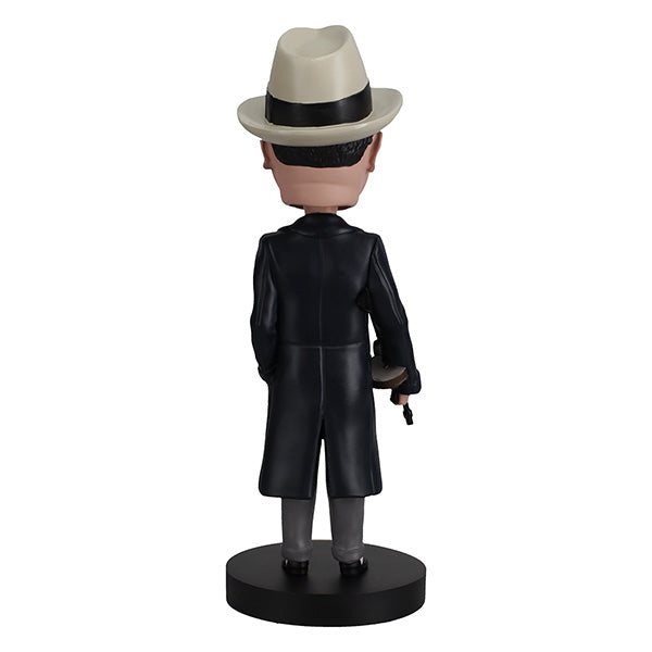 Al Capone Bobblehead standing 8 inches tall, featuring lifelike details, displayed on a shelf with a vintage theme in the background.
