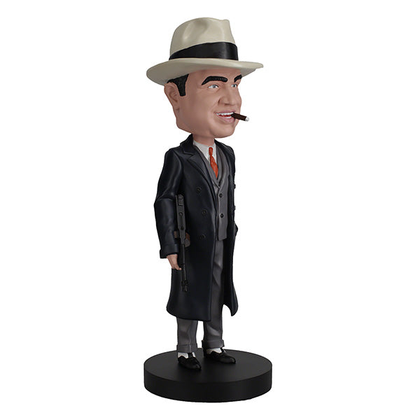 Al Capone Bobblehead standing 8 inches tall, featuring lifelike details, displayed on a shelf with a vintage theme in the background.