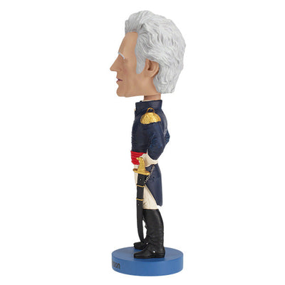 Andrew Jackson v2 Bobblehead crafted from heavyweight polyresin, featuring hand-painted details, displayed on a collector's shelf with a background of books.