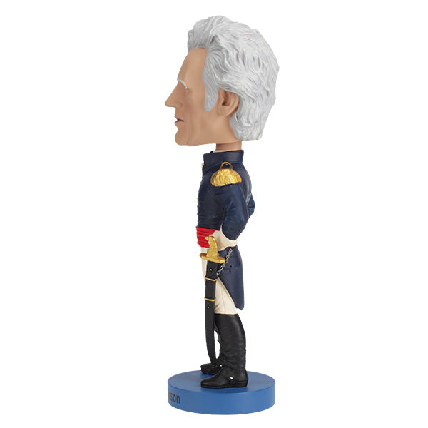 Andrew Jackson v2 Bobblehead crafted from heavyweight polyresin, featuring hand-painted details, displayed on a collector's shelf with a background of books.