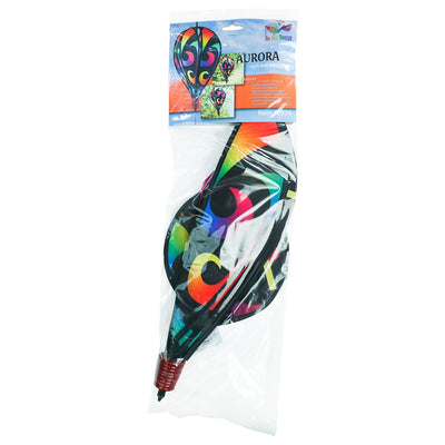 Aurora 6-Panel Hot Air Balloon in vibrant rainbow colors, displayed in a garden setting, spinning gracefully with colorful tail.