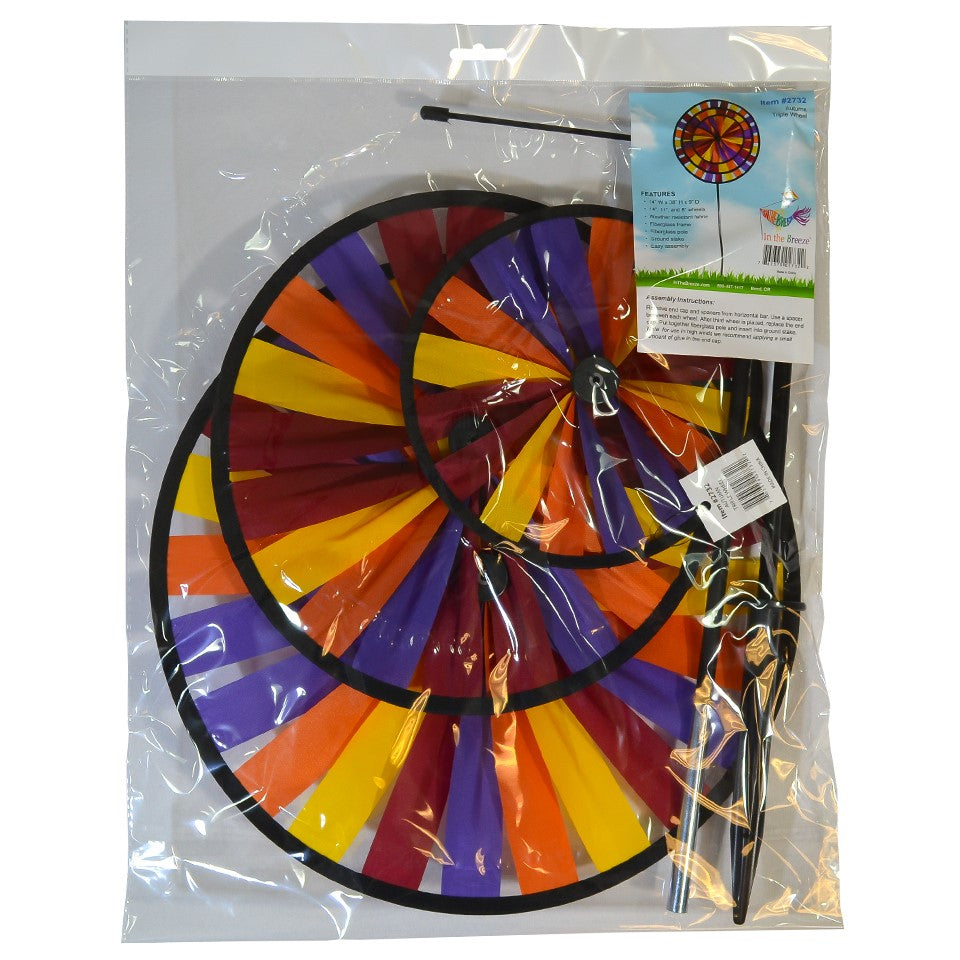 Vibrant Autumn Triple Wheel Spinner featuring three colorful wheels dancing in the wind, showcasing fall hues of red, orange, and yellow in a garden setting.