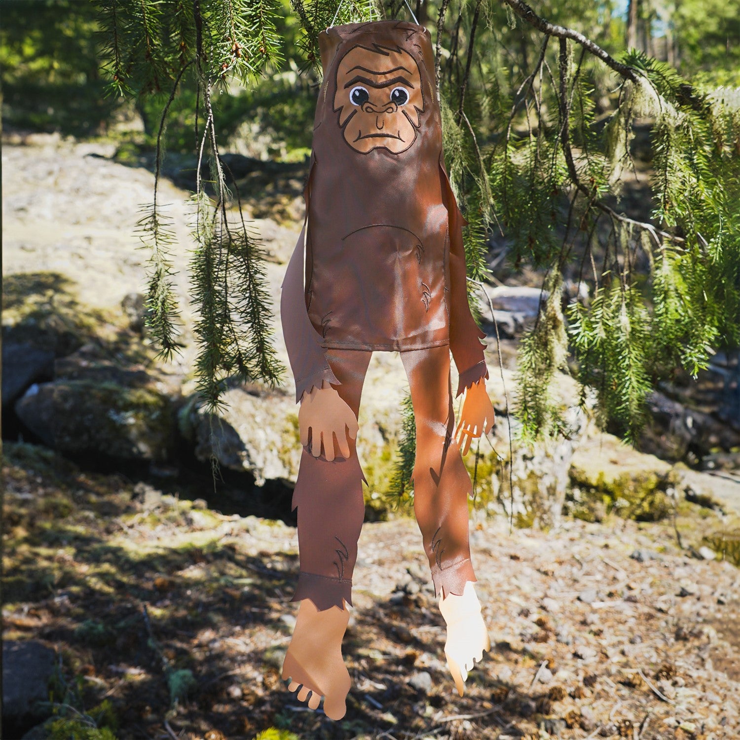 Baby Bigfoot 30" Breeze Buddy windsock featuring adorable applique and embroidery details, swaying gracefully in a garden setting.