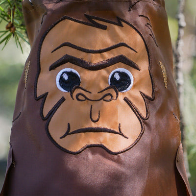 Baby Bigfoot 30" Breeze Buddy windsock featuring adorable applique and embroidery details, swaying gracefully in a garden setting.