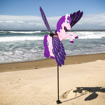 Baby Pegasus Whirligig garden spinner with colorful flying horse graphic and moving wings positioned in a sunny garden setting.