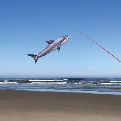 30-inch Baby Shark Fish Windsock hanging outdoors, showcasing its colorful design in a breezy setting, perfect for marine-themed decoration.