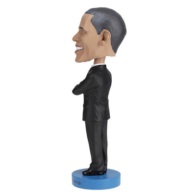 Barack Obama bobblehead, a hand-painted collectible figure showcasing the likeness of the first African American president, displayed against a neutral background.