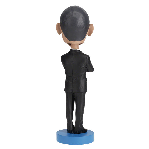 Barack Obama bobblehead, a hand-painted collectible figure showcasing the likeness of the first African American president, displayed against a neutral background.