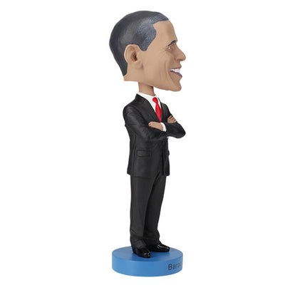 Barack Obama bobblehead, a hand-painted collectible figure showcasing the likeness of the first African American president, displayed against a neutral background.