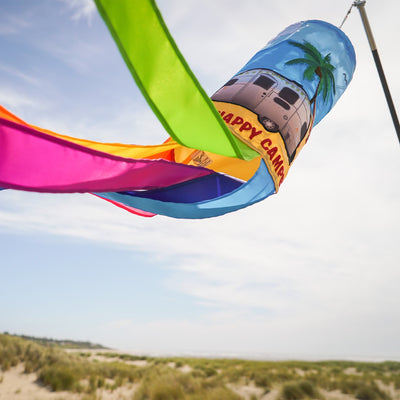 Colorful Beach Camping 40-inch Windsock featuring vibrant applique design hung outdoors, waving in the breeze above the ground.