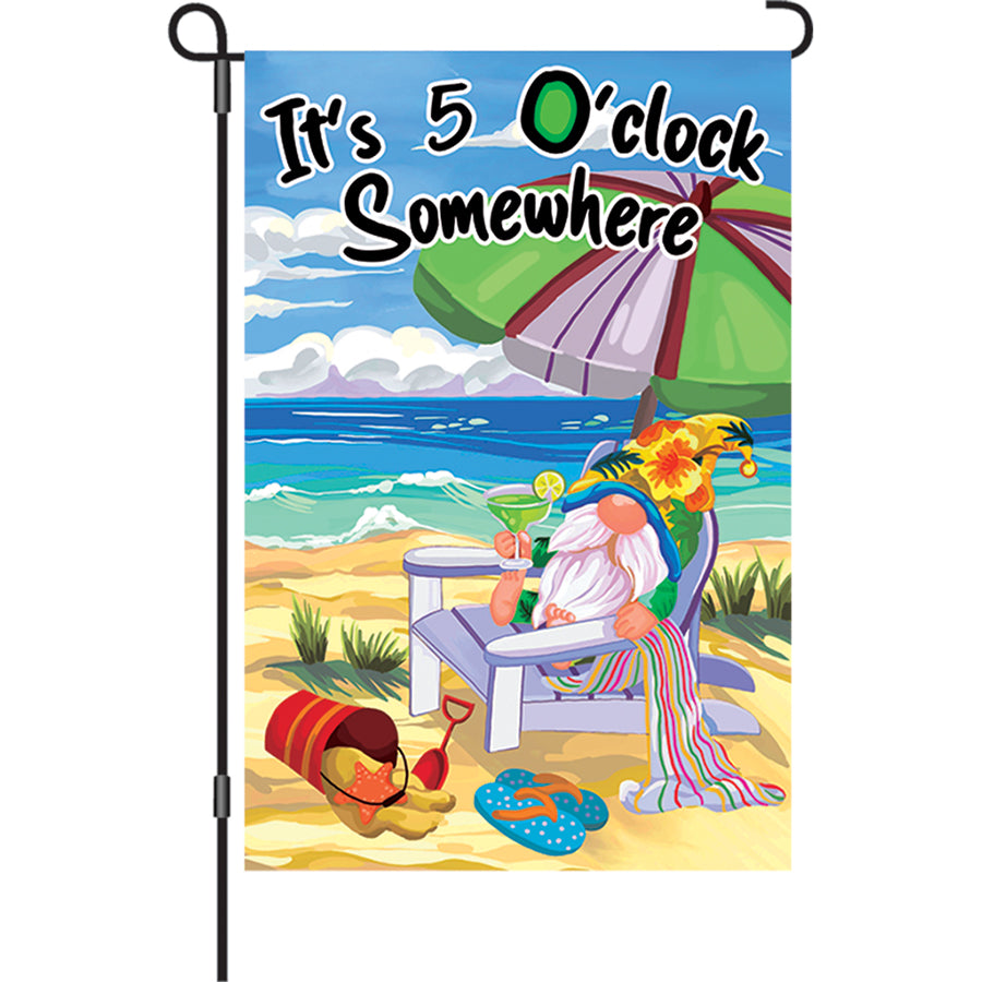 12 in. Beach Gnome garden flag displaying a colorful gnome under an umbrella with the text It's 5 O'Clock Somewhere, fluttering in the breeze.