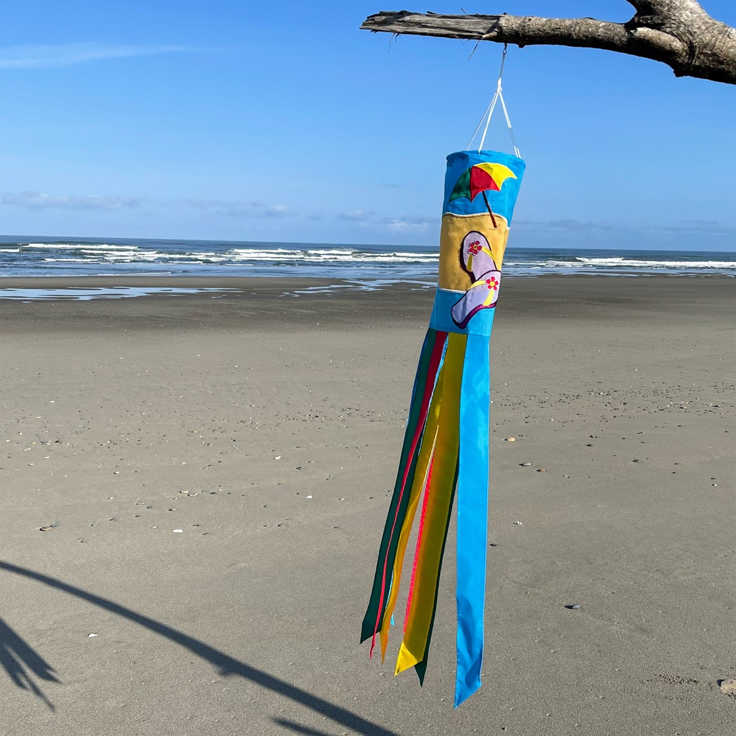 Colorful Beach Scene 40" Windsock with surfboards and whimsical tails on display, adding a coastal vibe to any outdoor setting.