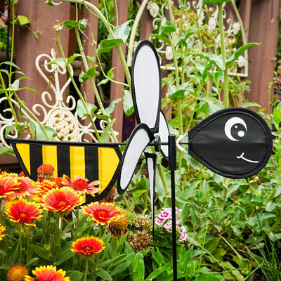 Bee Baby Spinner with colorful 12-inch wheel and bee design, elegantly spinning in a sunny garden setting on a fiberglass pole.