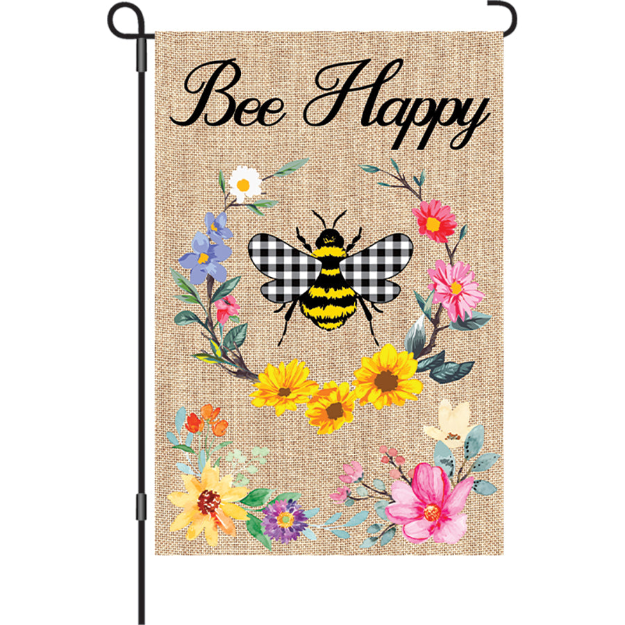 Bee Happy garden flag with cheerful bee design and gingham wings displayed in a garden setting, emphasizing vibrant colors and positive message.