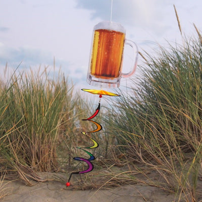 Beer Mug 5 O'Clock Spinner featuring a colorful beer mug design with a spinning wheel and curlie tail, displayed outdoors in a garden setting.