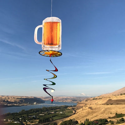 Beer Mug 5 O'Clock Spinner featuring a colorful beer mug design with a spinning wheel and curlie tail, displayed outdoors in a garden setting.
