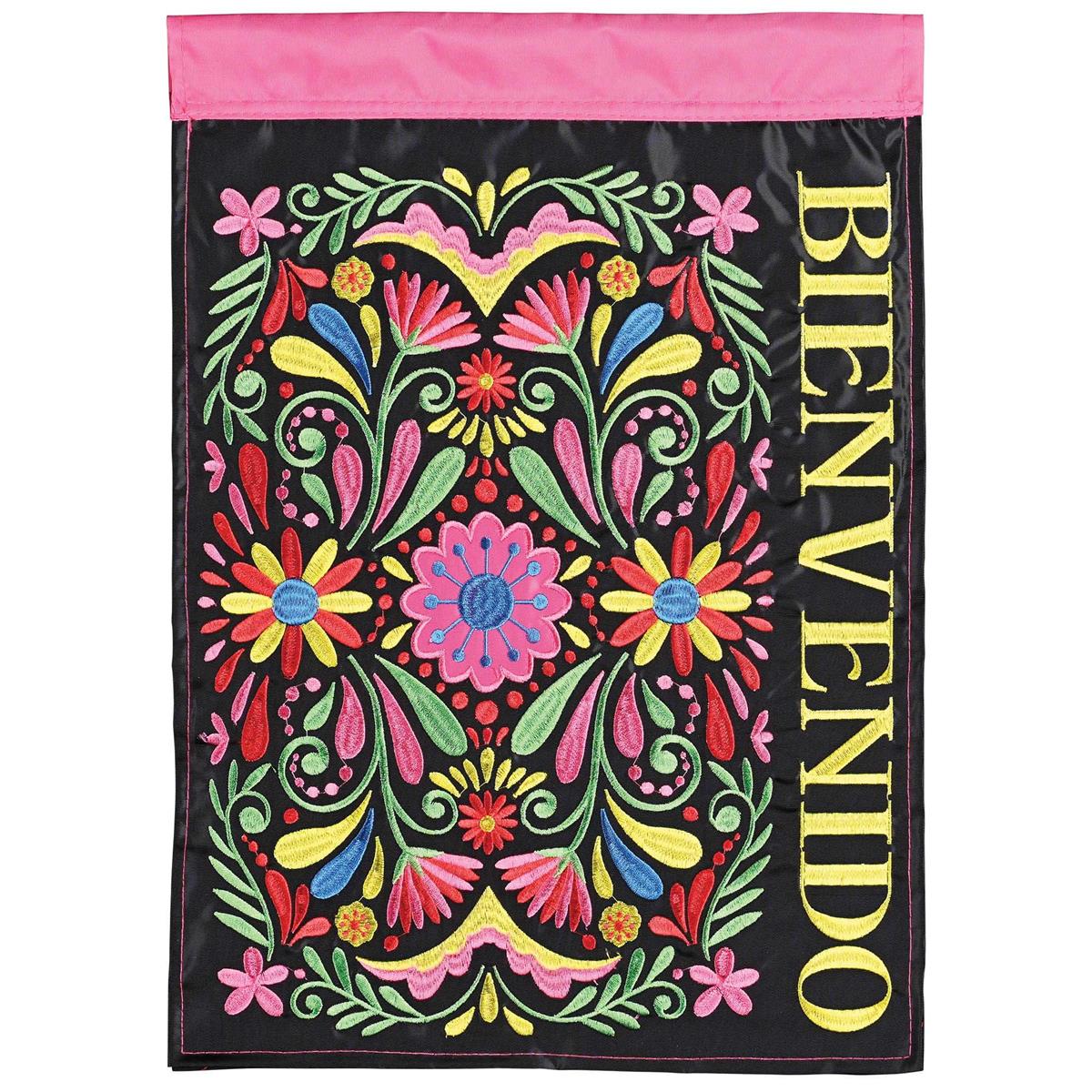 Bienvenido Banner Flag, double-sided 29x42 inches, featuring intricate fabric appliques and embroidery displayed on a flagpole near a garden.