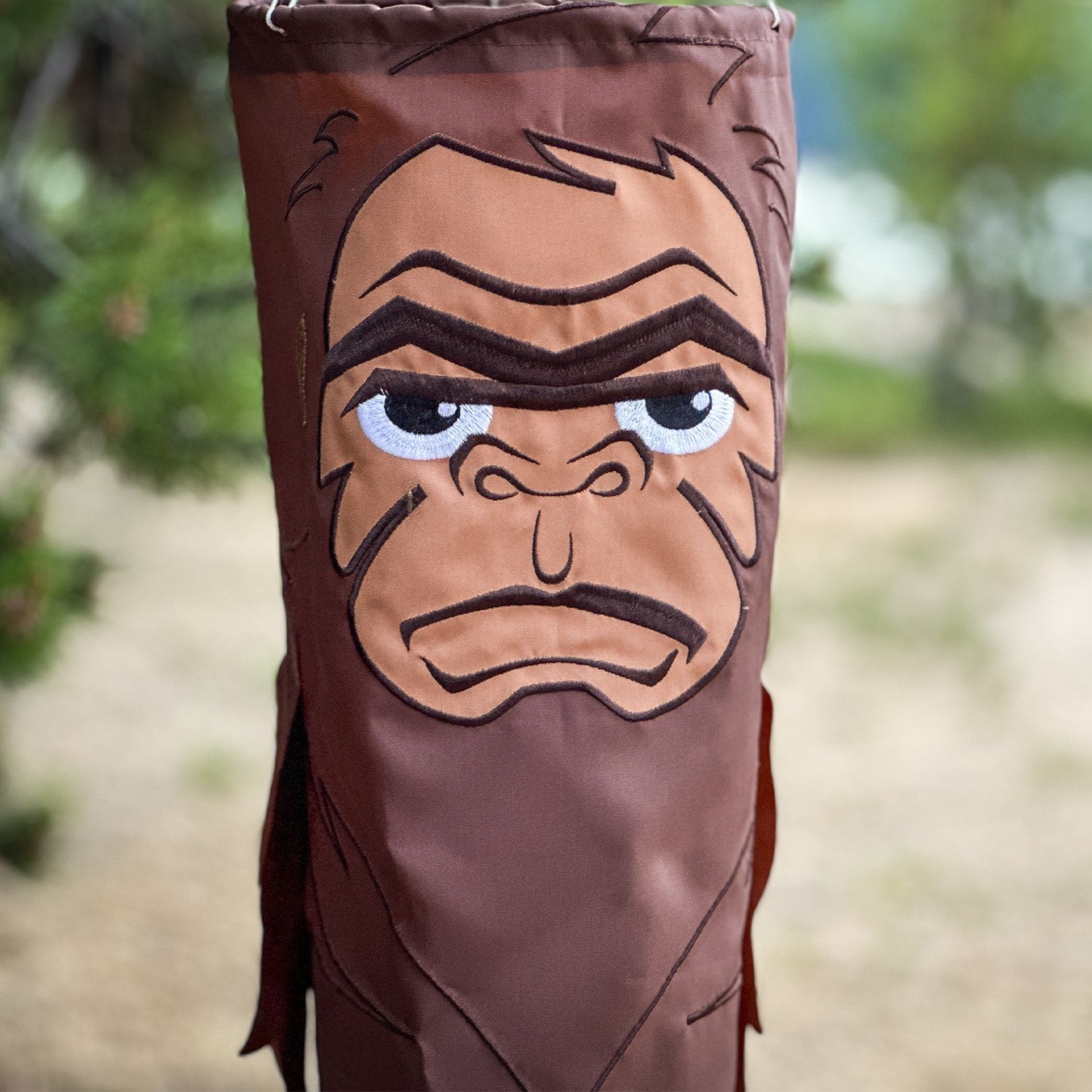 Bigfoot 50" Breeze Buddy windsock swaying in the outdoor breeze, showing its playful design and embroidered details, perfect for outdoor decor.