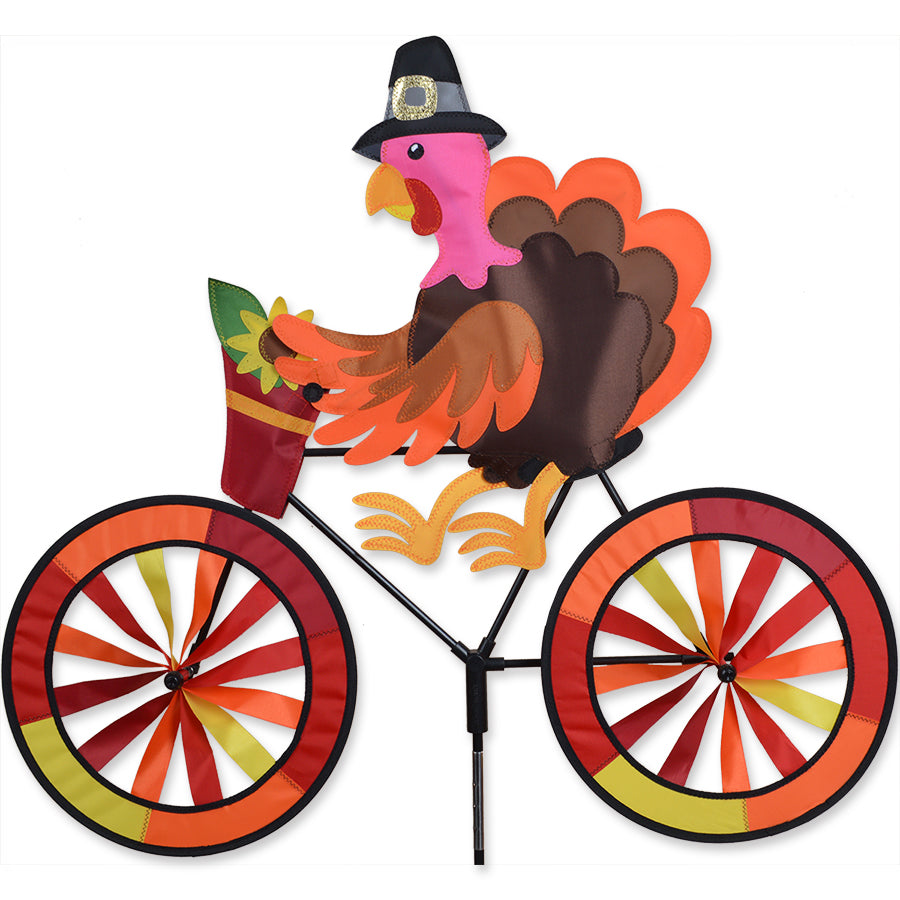 Bike Spinner - Turkey showing colorful turkey design, spinning gracefully in an outdoor garden setting, perfect for festive decor.